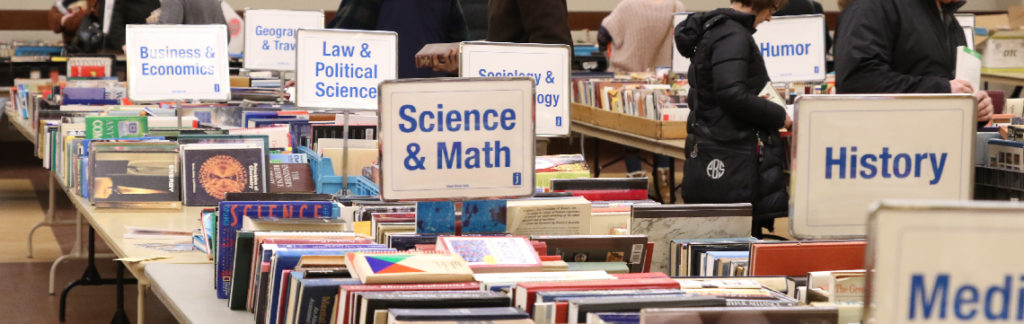 Rows of tables of books during one of the J's Used Book Sales.