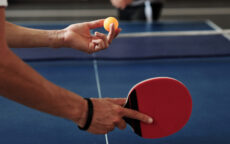 Close up of the hands of a man Serving Ping-Pong Ball